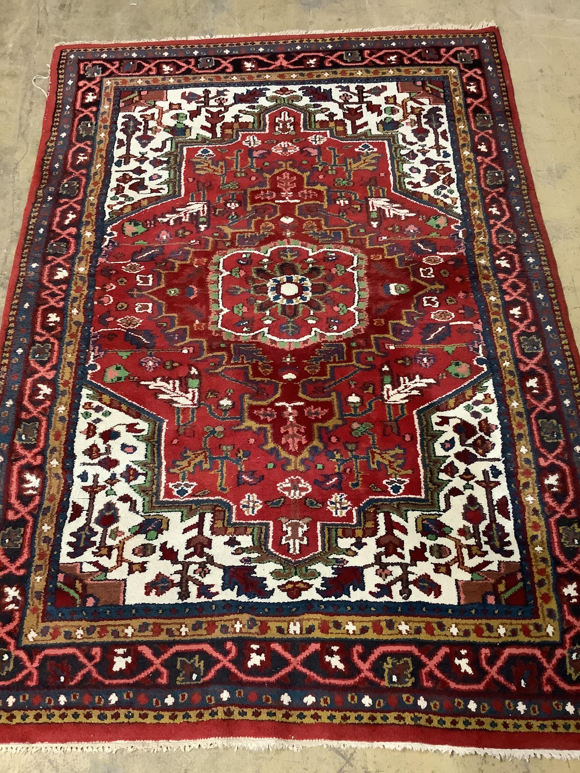 A Caucasian style red ground rug, 200 x 142cm